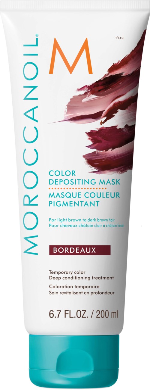 En tube med Moroccanoil fargeavsetter med brune malingsstrøk, blå tekst og blå hette.