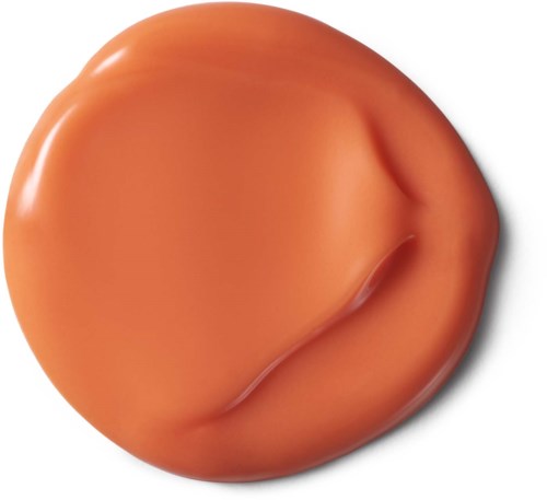 Pieni, oranssinvärinen, pyöreä esine, jolla on sileä pinta ja kaareva urassa toisella puolella.