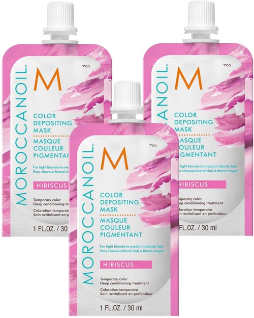Kolme vaaleanpunaisia ja valkoisia Moroccanoil-värinlevymaskin pulloja, tarkoitettu vaalealle tukalle, hibiscus-tuoksulla.