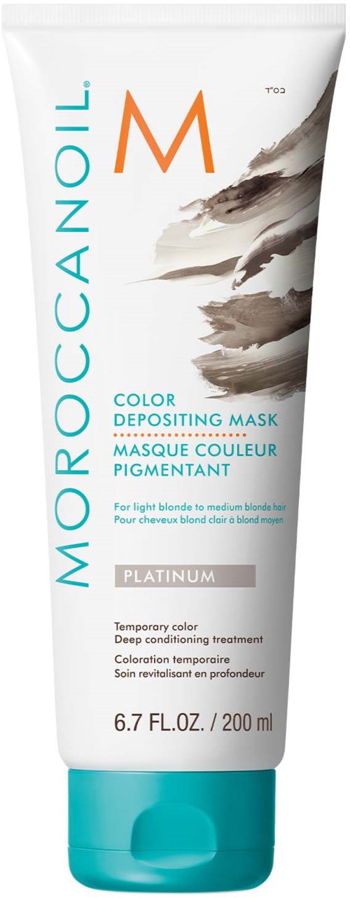 En vit tub med teal lock, märkt Moroccanoil, med grå och orange detaljer, för färgdepositerande hårmask.