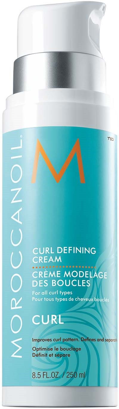 A tall turquoise bottle with white and silver cap, labeled Moroccanoil Curl Defining Cream, designed for hair styling.