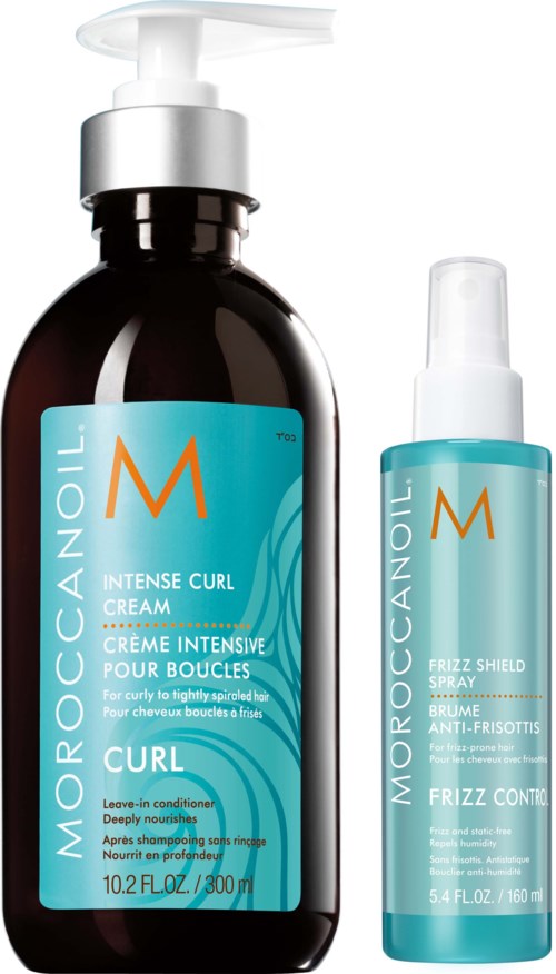 Two bottles of Moroccanoil hair products, one for intense curl cream and one for frizz control spray.