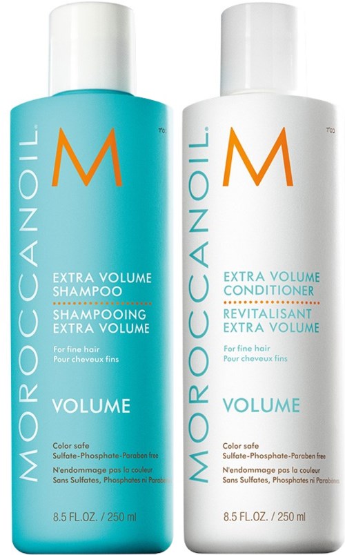 Two bottles of hair care products: one shampoo and one conditioner, both for extra volume and for fine hair.