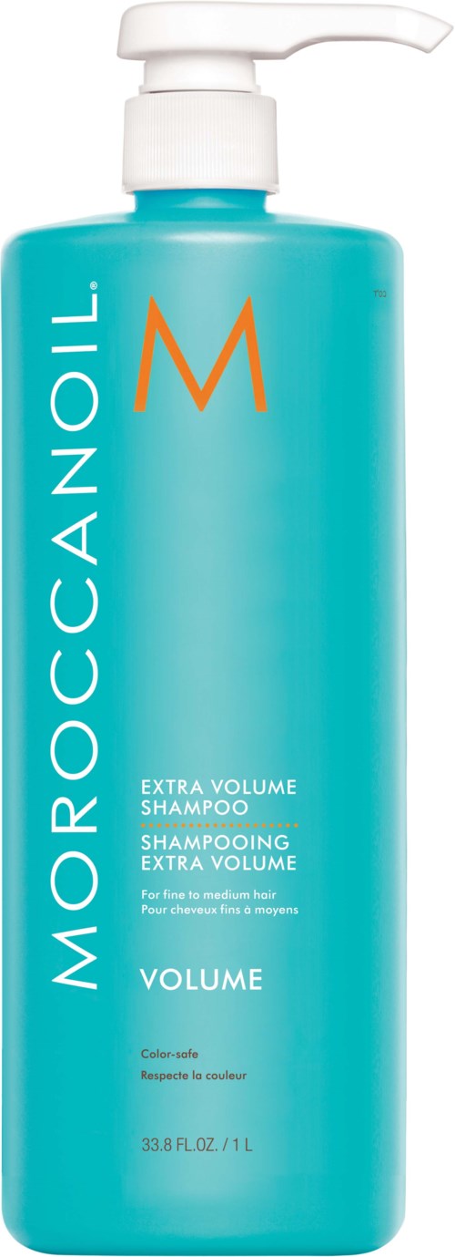 En blå flaska med pump, märkt Moroccanoil Extra Volume Shampoo, för extra volym hårvård.