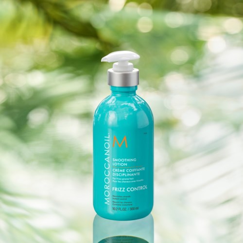 A blue bottle labeled Monoccani with a pump, suggesting it is a skincare or haircare product.