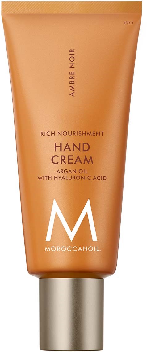 Käsivoideputki beigestä oranssista väristä, siinä lukee 'Rich Nourishment Hand Cream' ja 'Moroccanoil.'