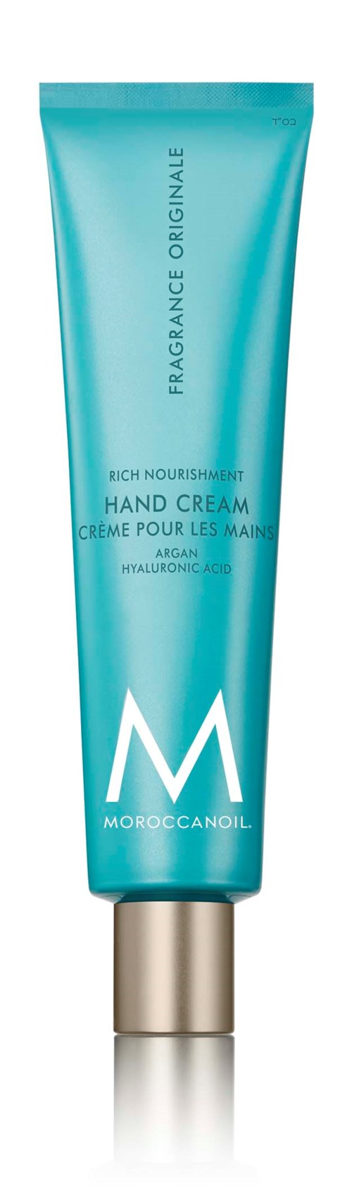 Sininen käsivoideputeli kulttaganttineen, merkinnällä 'Moroccanoil' ja 'Rich Nourishment Hand Cream.'