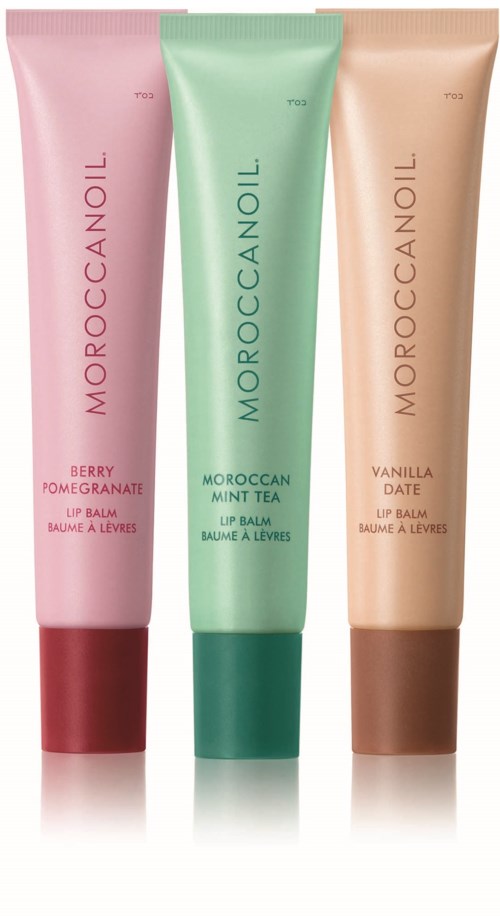Three colorful tubes of Moroccanoil lip balm in different flavors: berry pomegranate, Moroccan mint tea, and vanilla date.