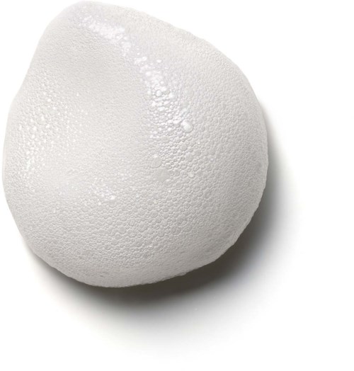 A white egg with a slightly pointed end, covered in tiny water droplets.
