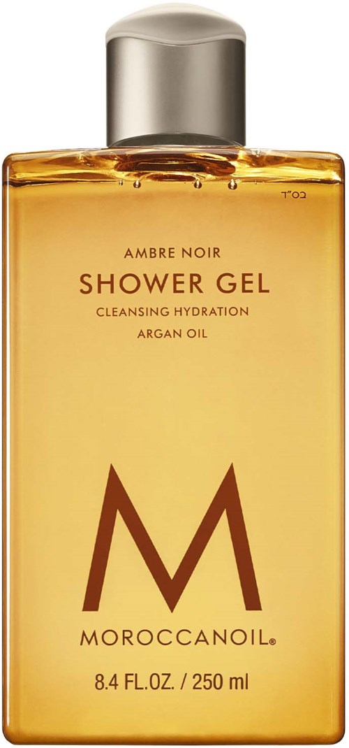 En guldfärgad duschtvålflaska med silverlock, märkt Moroccanoil Ambre Noir, 250 ml. Den är för rengöring och återfuktning.