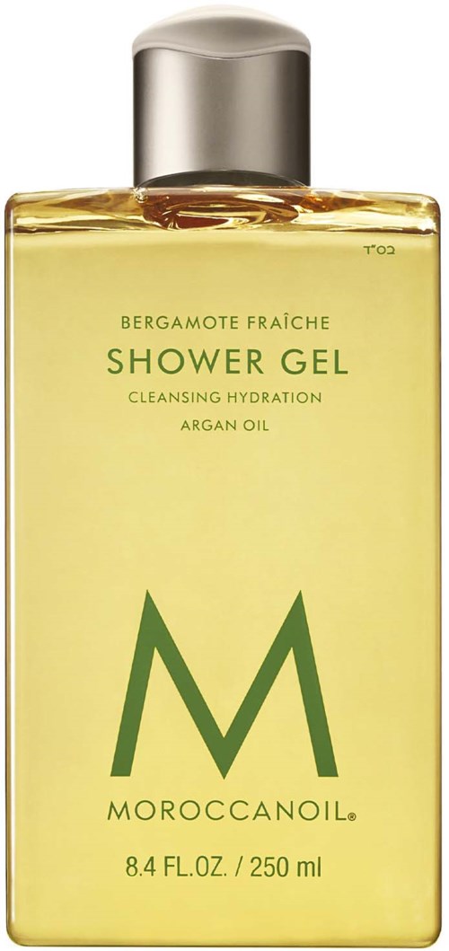 En gul flaska med Moroccan Oil duschgel med silverlock och grönt textetikett.