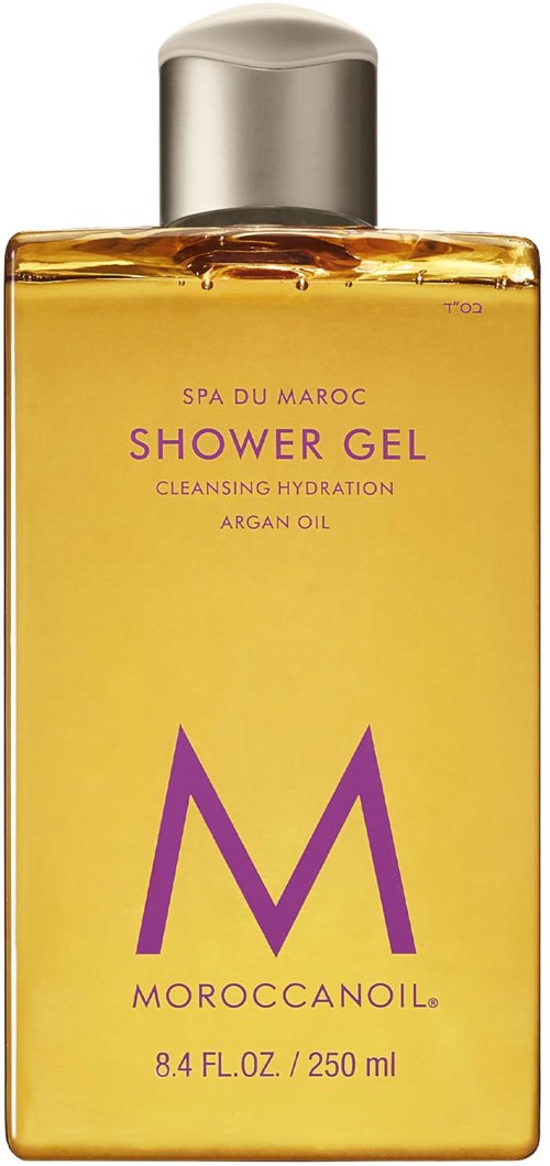 Keltainen suihkugeelipullo hopeisella kannella, merkinnällä 'Moroccanoil, Shower Gel, Argan Oil, 8,4 fl oz.'