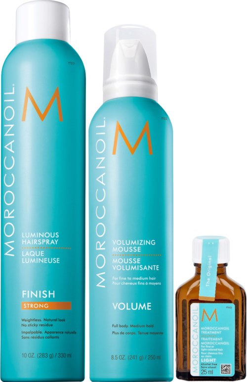 Three blue bottles of Moroccanoil hair products with orange and white labels are shown.