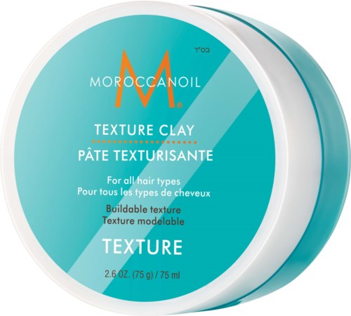 Ein runder Behälter mit Moroccanoil Textur Clay, hellblau für alle Haartypen, mit Produktdetails und Markenlogo.