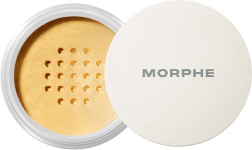 En liten dosa med gul puder och hål, märkt MORPHE, möjligtvis makeup eller ansiktspuder.