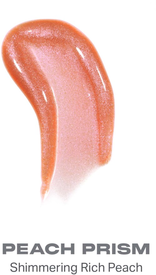 Ett glansigt, skimrande persikofärgat sminkprodukt märkt Peach Prism. Det ser slätt och glänsande ut.