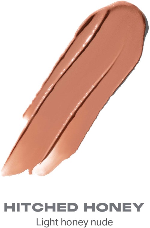 En provbit av ljus honungsfärgad nude sminkprodukt med en borstad textur.
