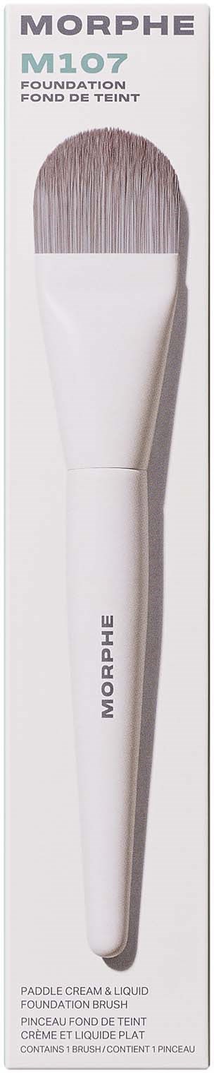 A makeup brush with a white handle and silver bristles, packaging labeled Morphe M107 foundation brush.