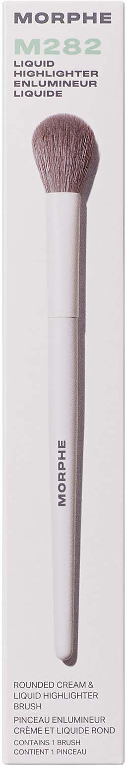 A makeup brush with a white handle and a rounded, soft pink tip, in packaging with gray and white text.