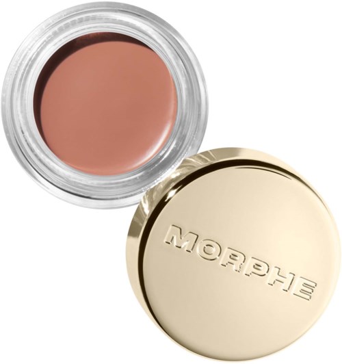 Ett litet förvaringsburk med beige makeup och ett glänsande guldlock med märket "Glossier".