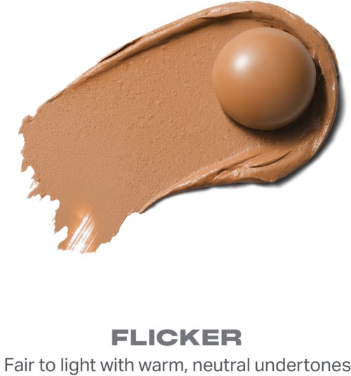 Bilden visar en beige makeupprodukt med en rund sak ovanpå, märkt Flicker, med slät yta och neutrala toner.