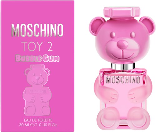 Pinkfarbene Bärenform-Flasche mit 'Moschino' und Bubble-Gum-Duft, neben pinker Verpackung.