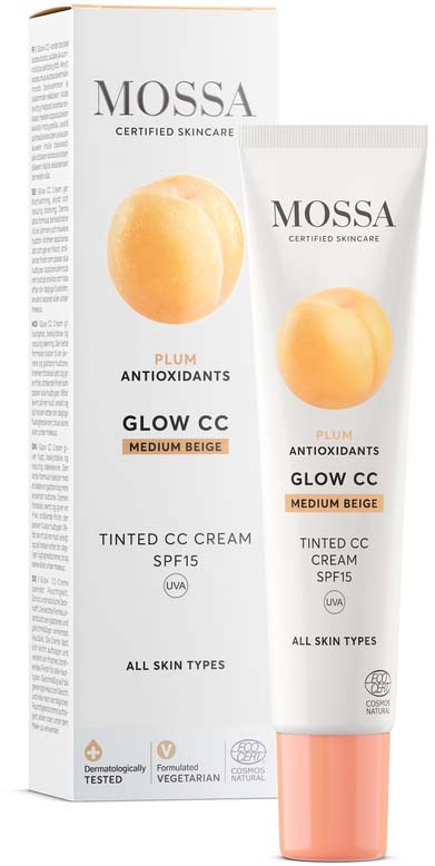 Tub med Mossa Glow CC-kräm i medium beige med SPF 15 bredvid förpackningen. Boxen visar en persikobild.