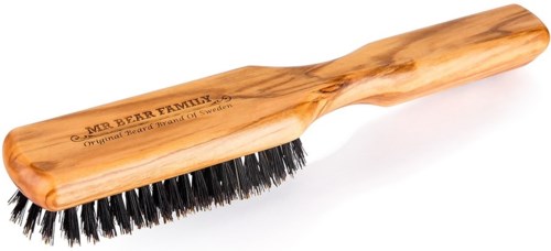 A wooden brush with black bristles and a handle, labeled Mr. Bear Family, made in Sweden.