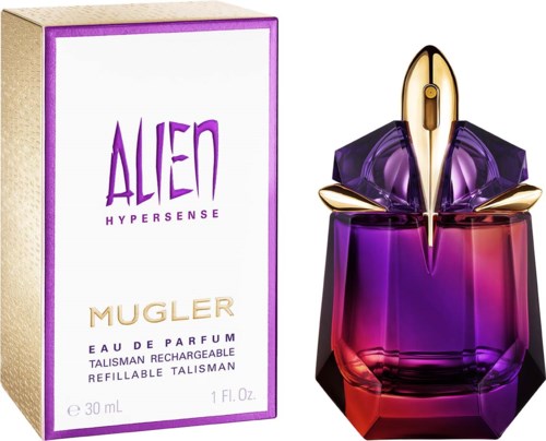 Een parfumfles in de vorm van een ruimteschip met paarse en gouden details, naast de doos gemarkeerd 'Alien Mugler'.