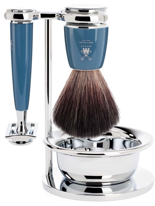 A shaving brush and razor holder with blue handles, holding a shaving brush with brown and black bristles.