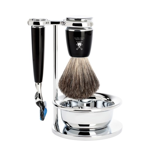A shaving set with a safety razor, shaving brush, and holder in a shiny silver stand.