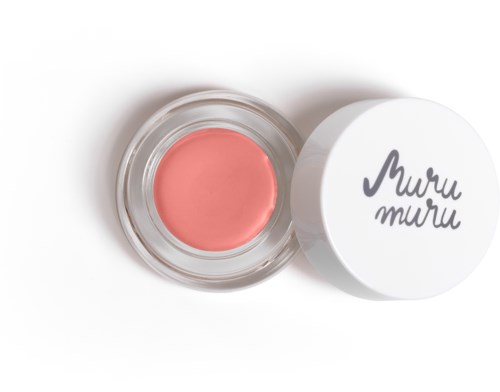 Ein kleiner Behälter mit rosa Creme oder Wachs, neben einem weißen Deckel mit schwarzer Schrift.
