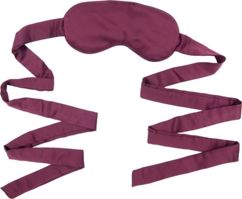 Eine lila Schlafmaske mit langen, wellenförmigen Bändern.