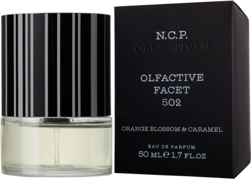 En parfyllflaska med svartvitt randigt mönster bredvid en svart box med silvertext, märkt 'Olfactive Facet 502' och doft 'Orange Blossom & Caramel'.