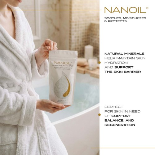 Person in bathrobe holding a package of Nanoil Dead Sea bath salt in a bathroom setting.