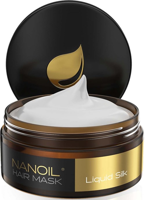 A brown jar with black and gold label, filled with white cream and a gold leaf design on the lid.