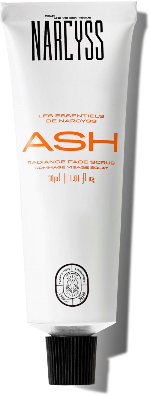 Eine weiße Tube Narcyss Ash Gesichtspeeling mit schwarzem Deckel, zeigt Produktdetails in Schwarz und Orange.
