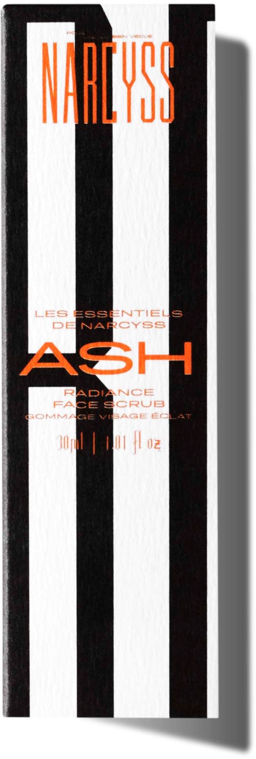 Eine lange Verpackung mit schwarzen und weißen vertikalen Streifen und orangefarbenem Text, erwähnt Narcissus, Ash und Gesichtsscrub.