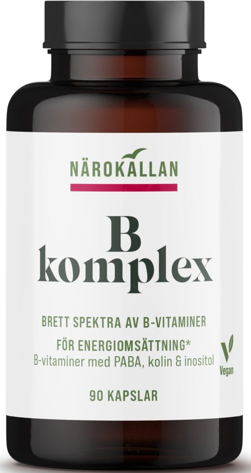 En mörk flaska med vit etikett som visar grön och svart text om B-vitaminer och energistöd.
