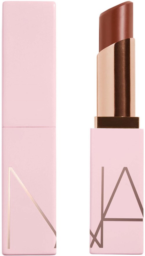 Pink lipstick with a brownish shade inside, next to its matching pink box. Modern design with large letters.