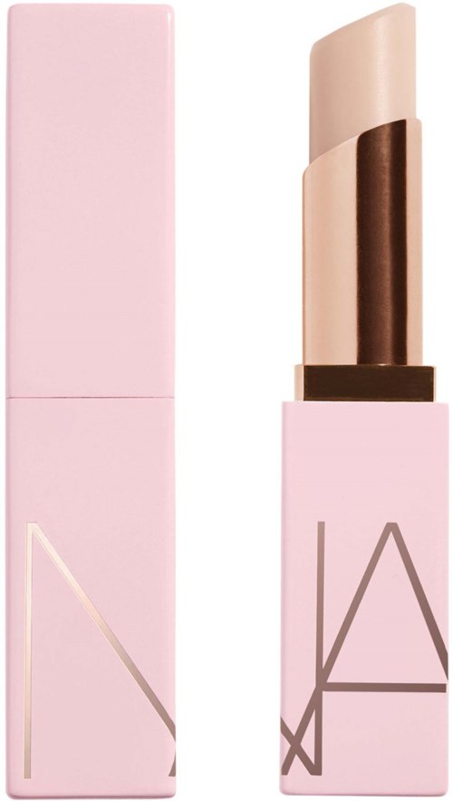 A pink lipstick tube with the brand name NARS, partially open showing the beige lipstick.