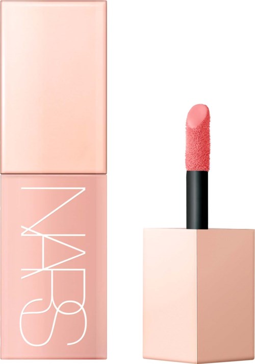 A pink lipstick with a square base next to its matching pink box. The lipstick has a soft, rounded tip.