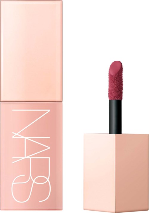 A pink lipstick with the cap off, showing the lip color. The lipstick is in a light pink case.