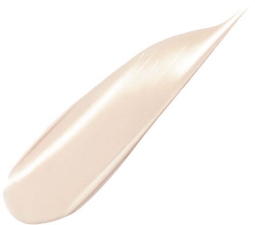 En beige eller ljuskrämfärgad kräm eller lotion på en spatel. Föremålet används för hud- eller kosmetiska ändamål.