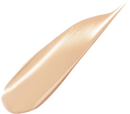 En beigefärgad kräm- eller concealer-tub med spets för exakt applicering.