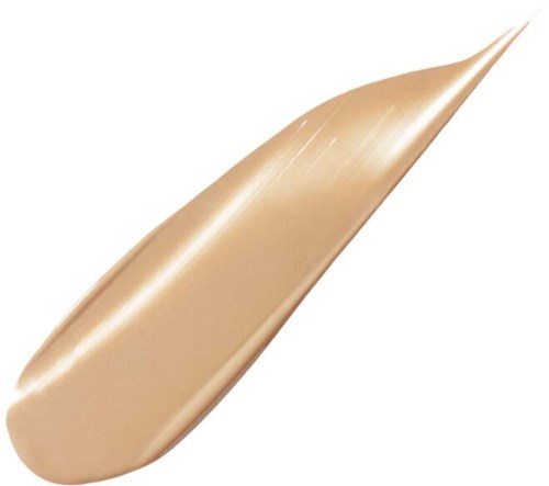 Ett beige makeupprodukt med en slät, rundad form och en avsmalnande, spetsig spets.