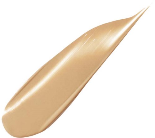 Ett beige skönhetsprodukt som är utmejslat som en tårform, slät och glänsande.