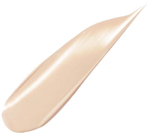 En beige eller ljusfärgad kräm eller lotion på en spatel eller applikator.