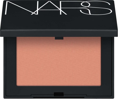 A NARS makeup blush in a black case with white logo, peach-colored powder inside.