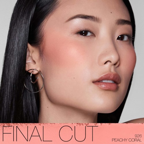 A woman with smooth skin and silver earrings looks confidently at the camera.